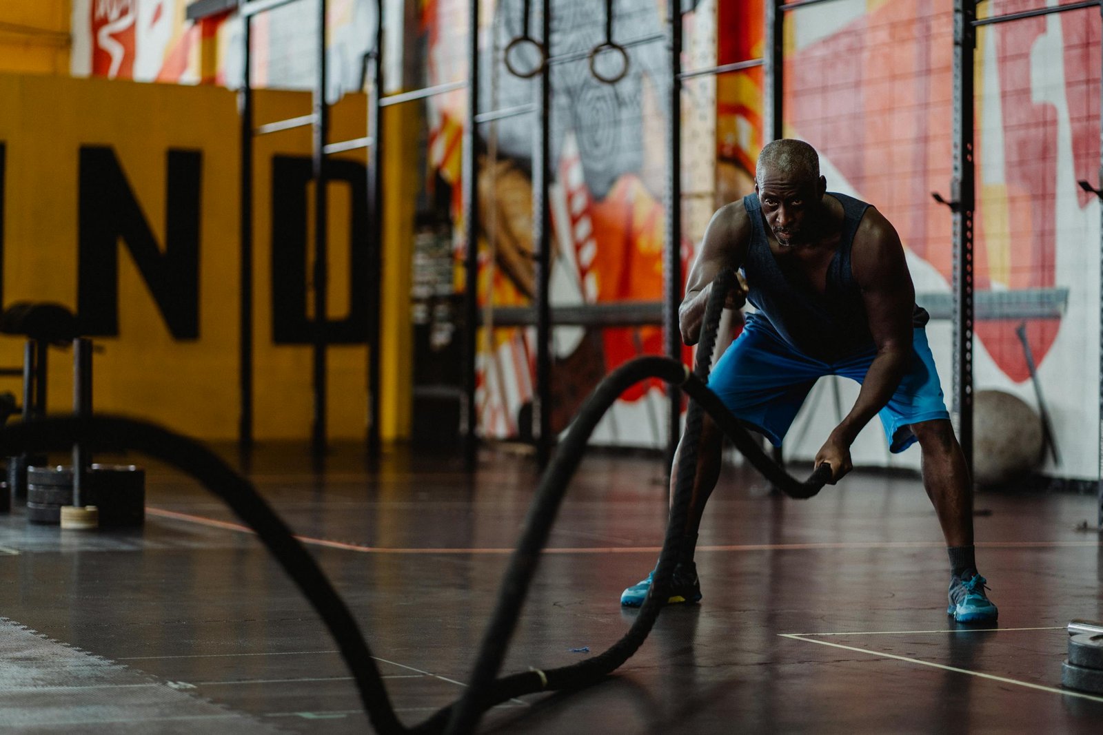 Man in Blue Shorts Doing Exercise with Battle Ropes