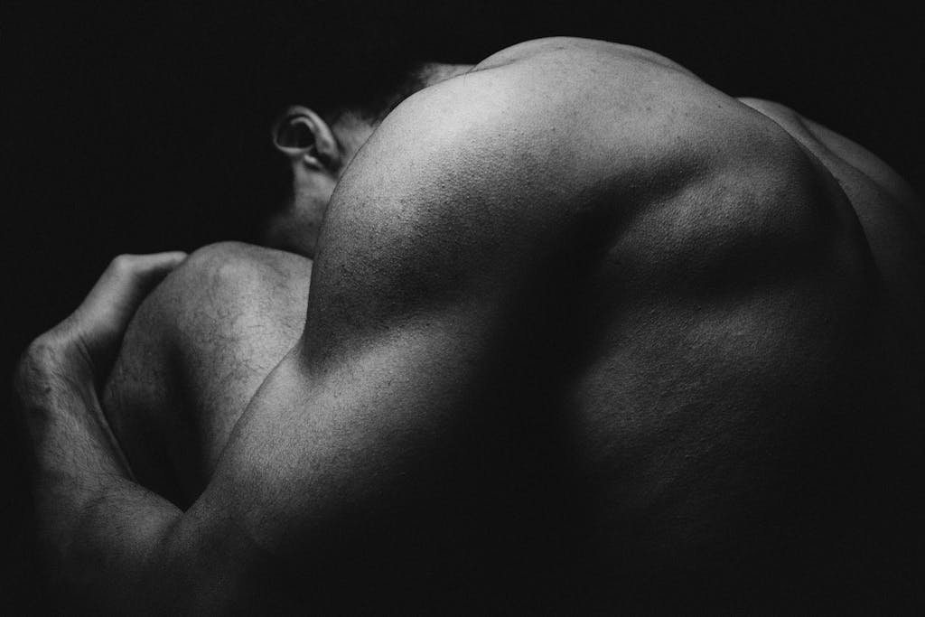 Black and White Photo of Muscular Back of a Man