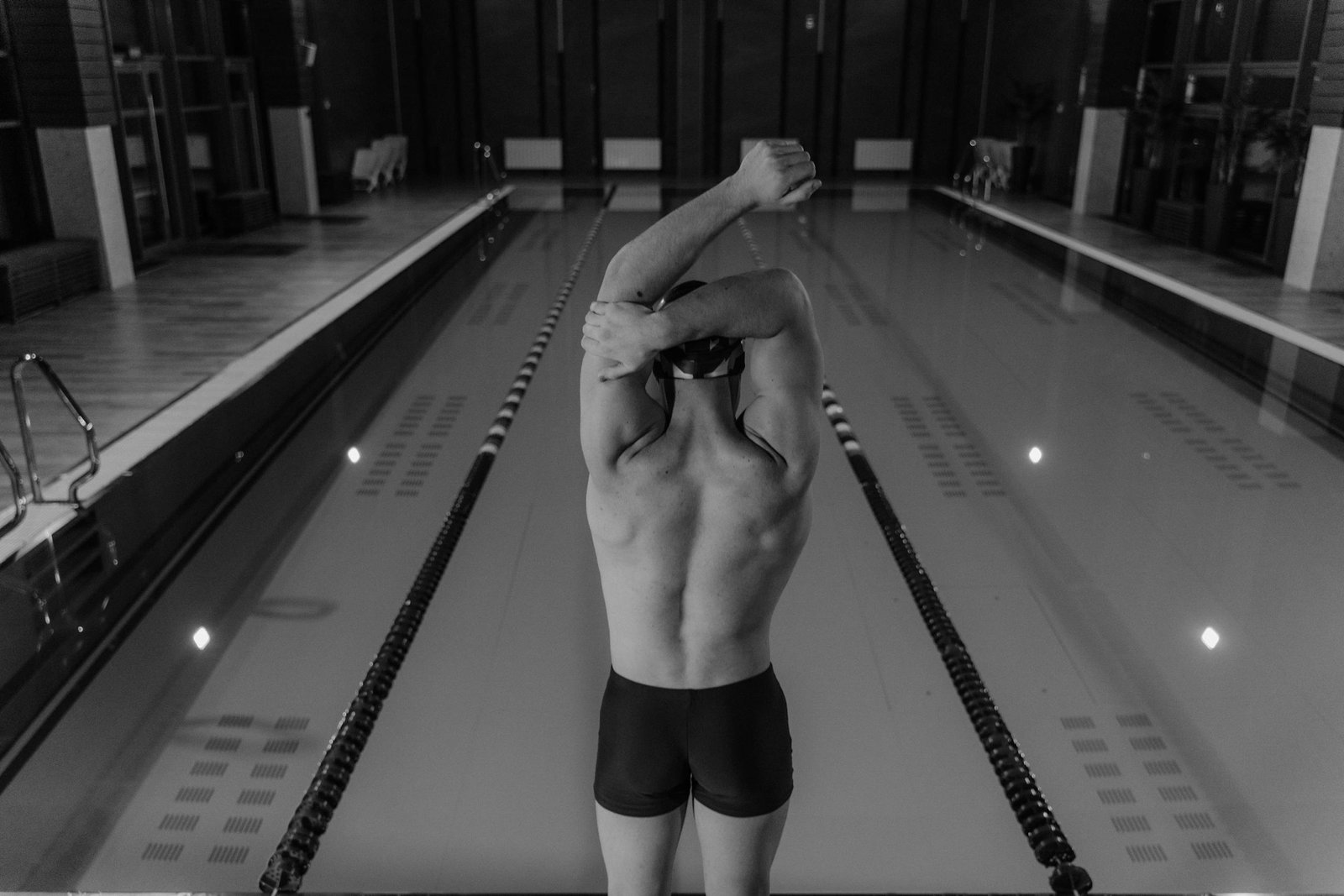 Man in Black Shorts Standing on Swimming Pool