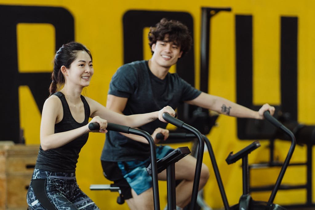 A Couple Using Elliptical Trainers