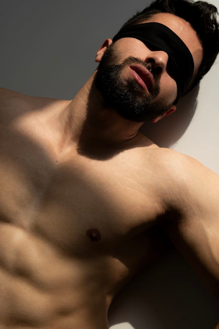 Shirtless Muscular Man with Covered Eyes